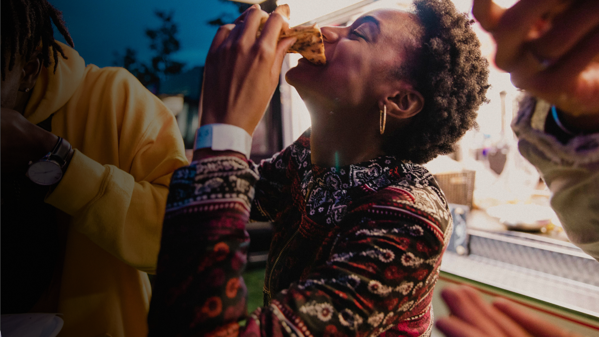 A woman eating a meal with friends