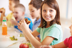young Girl smiling eating lunch young Girl smiling eating lunch