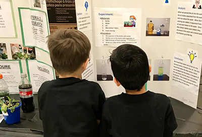 Children reading science fair projects Children reading science fair projects at Enders Salk
