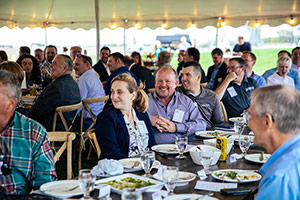 Smiling dinner guests at the Shared Impact Dinner Smiling dinner guests
