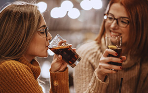 Child drinking from glass of low or no calorie sweetened cordial