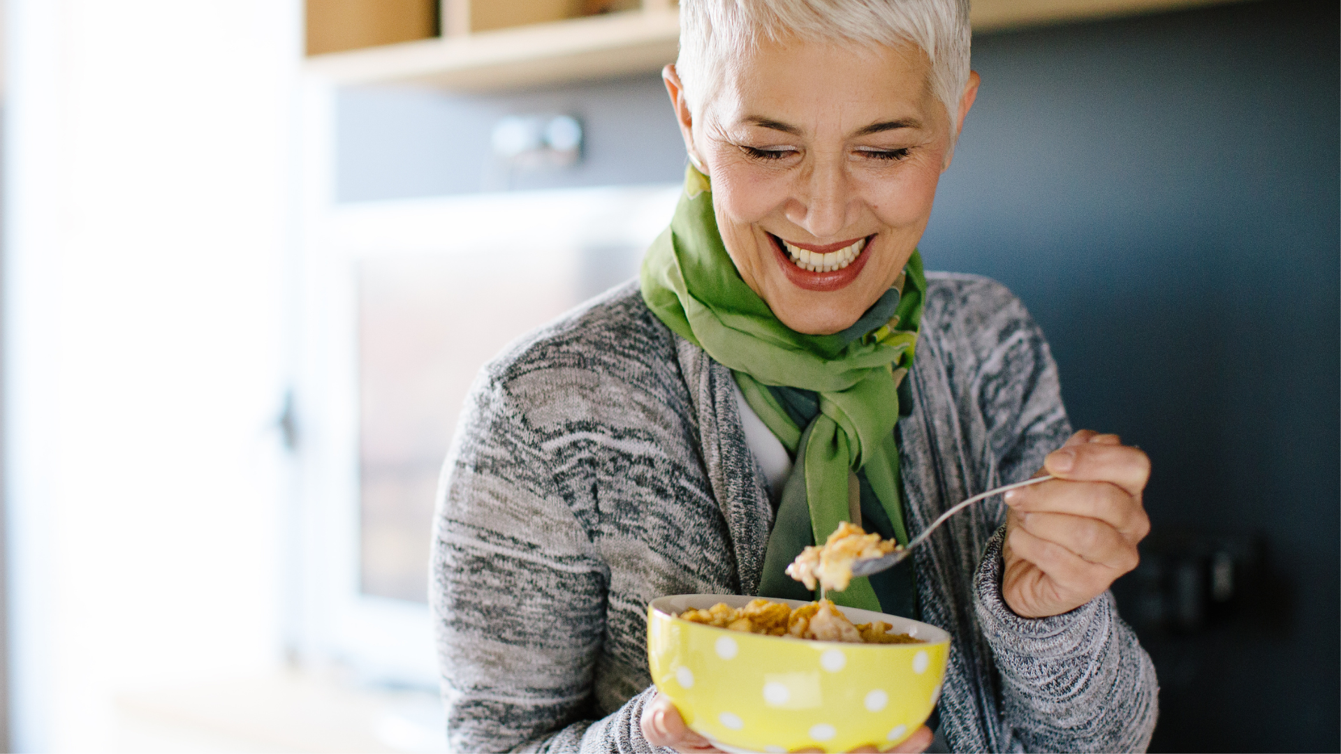 Woman smiling and enjoying a bowl of cereals