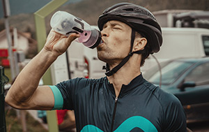Cyclist drinking a sports nutrition beverage