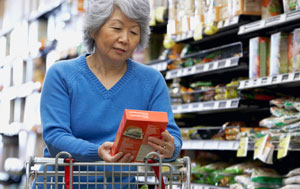 Asian woman reading on-pack labeling
