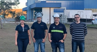 Four colleagues standing in front of Guarani site, Brazil