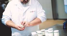 Tate & Lyle scientist demonstrating with jars of yoghurt