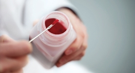 Small amount of powdered ingredient being measured out of a tub