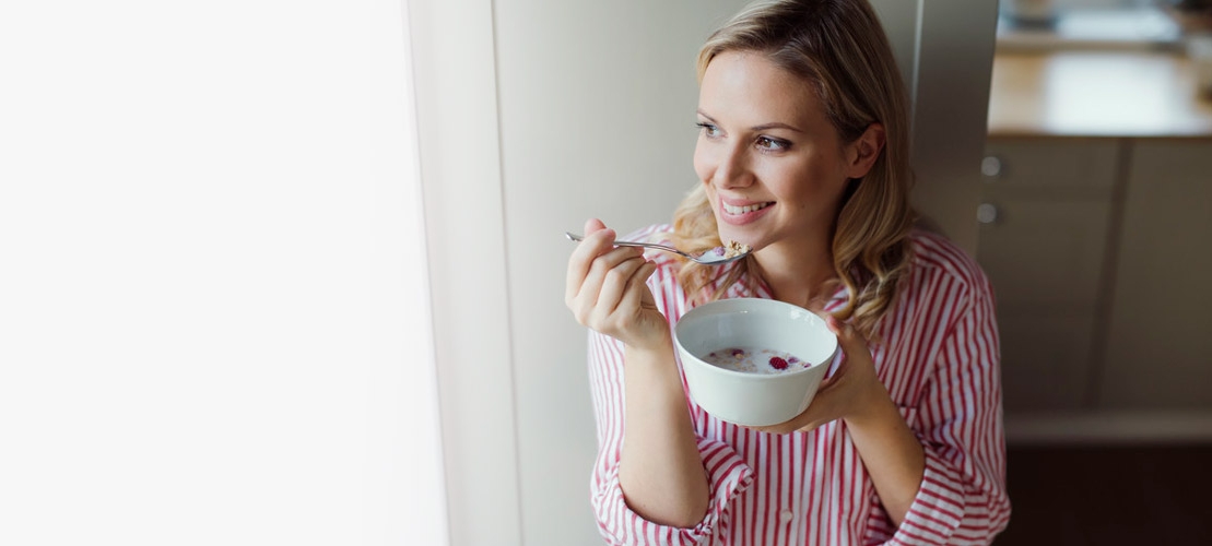 Woman eating cereal with milk