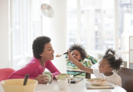 Children feeding a mother 
