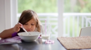 child eating breakfast child eating breakfast