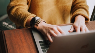 Subscribe to our media relations email Hands typing on a laptop